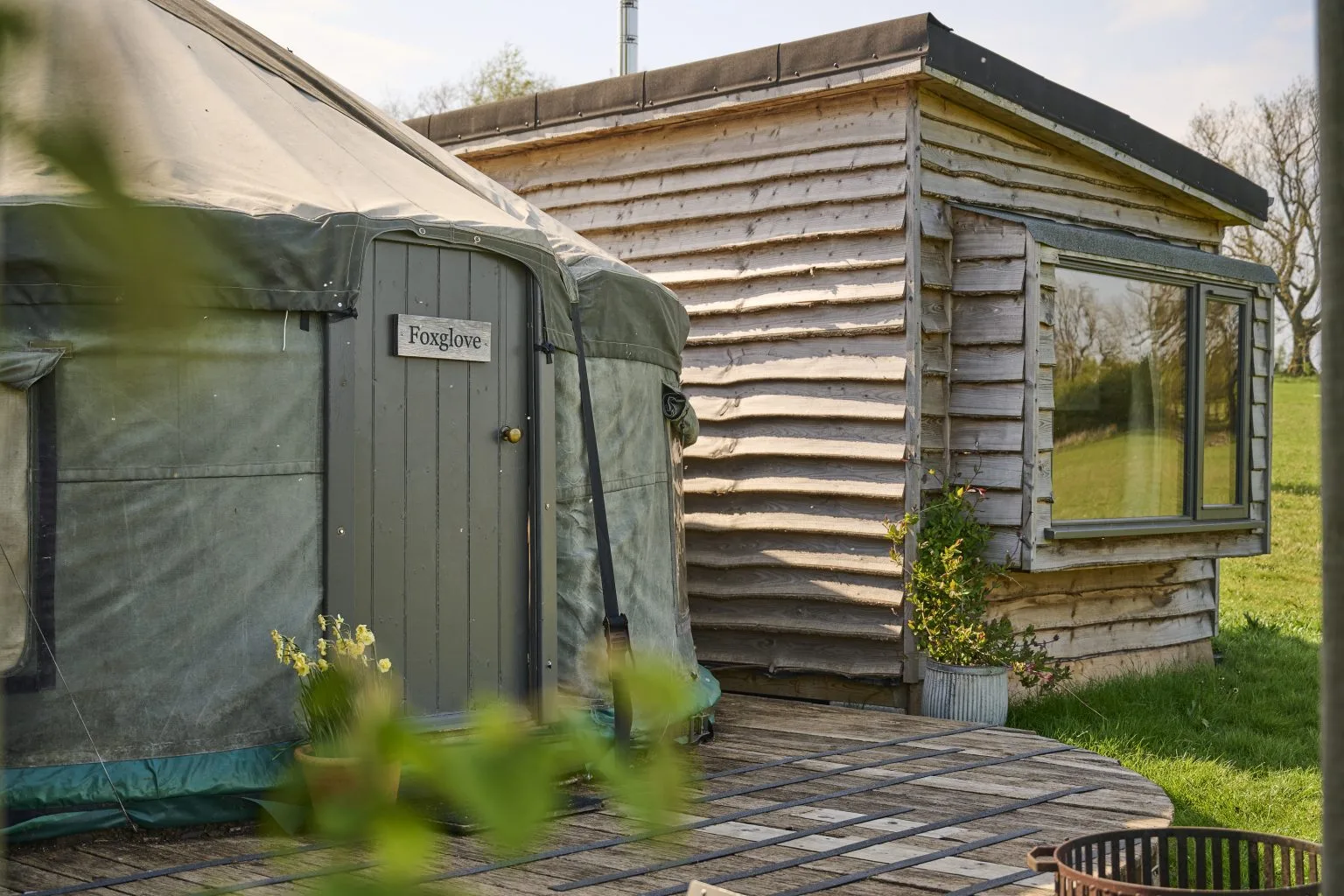 A Cabin Yurt with its adjoining wooden bedroom cabin at Swinton Bivouac