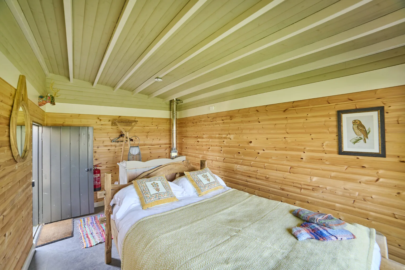 The wood-panelled bedroom of a Cabin Yurt