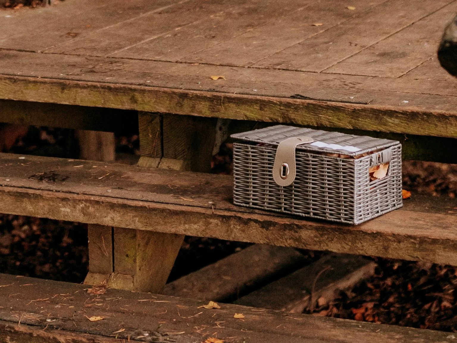 A breakfast hamper on a wooden table for glamping guests